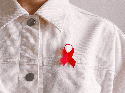 A red ribbon pinned on a shirt