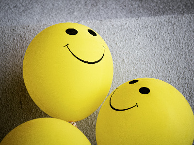 Yellow tennis balls with smiling faces